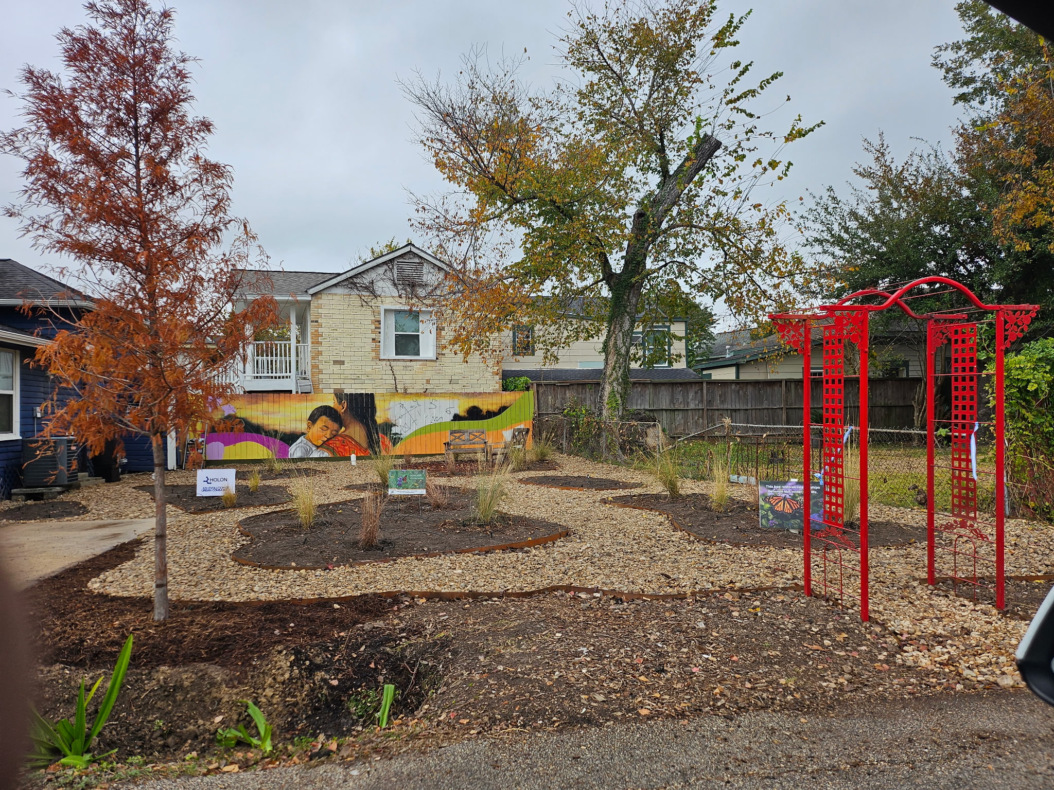 Community garden with mural and native plantings — DIY and professional paths